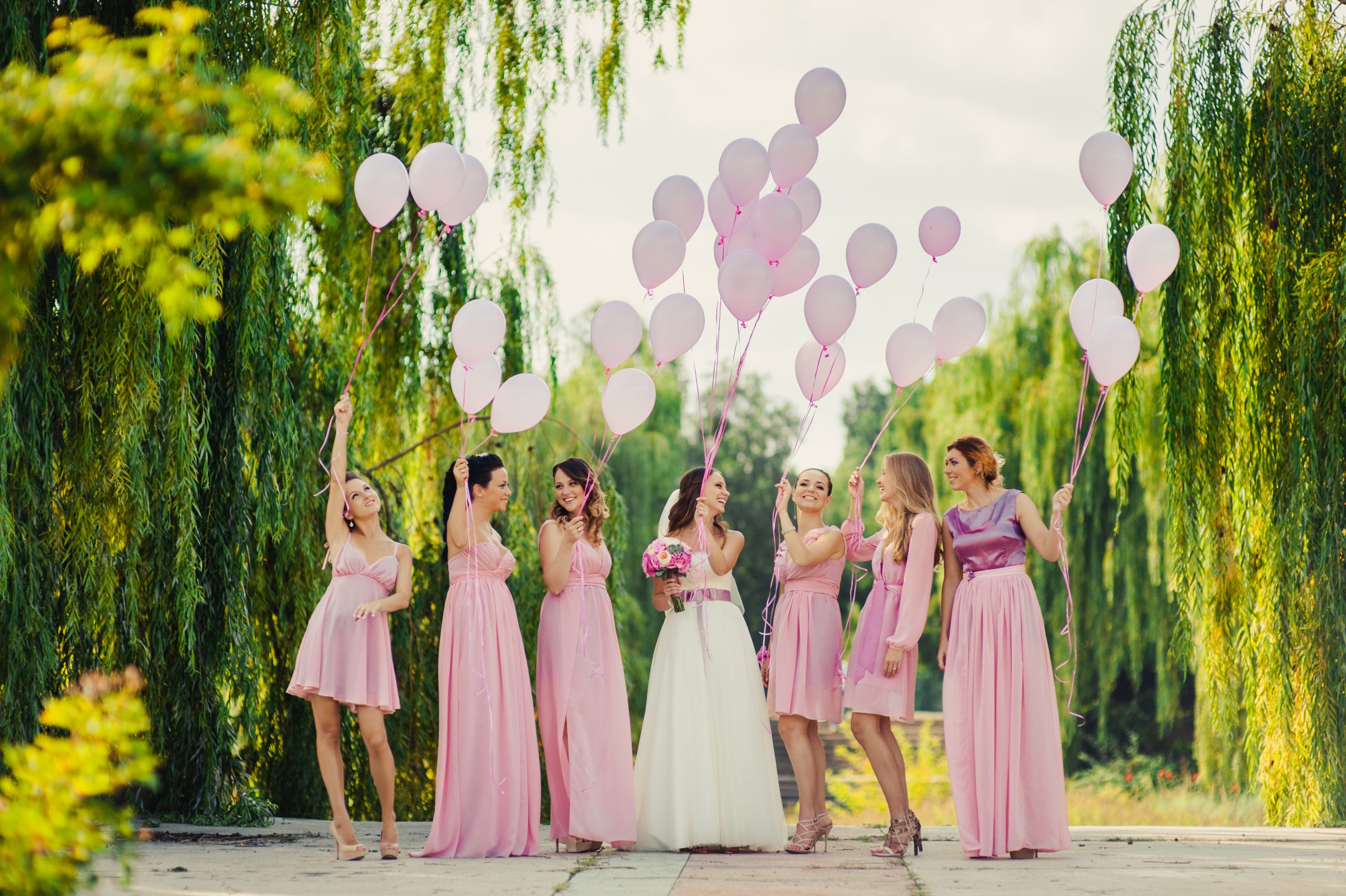 Beautiful,Happy,Smiling,Bride,With,Bridesmaids,In,Light,Trendy,Pink